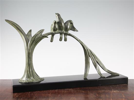 A French Art Deco patinated bronze group modelled as three birds sitting upon an arched leaf, 31.5in.